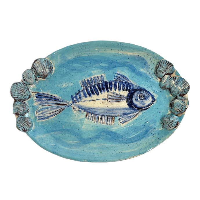 Ceramic plate with a fish design on a light blue background