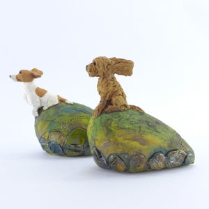 Ceramic sitting cockapoo in the wind (on a small hill)