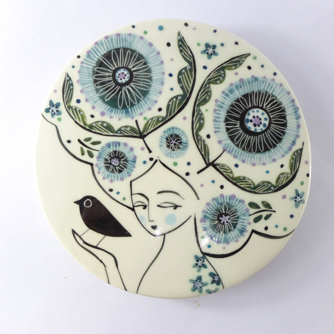 Round plaque lady with a bird