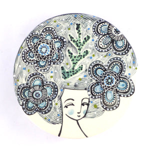 Round plaque lady with flowers in her hair